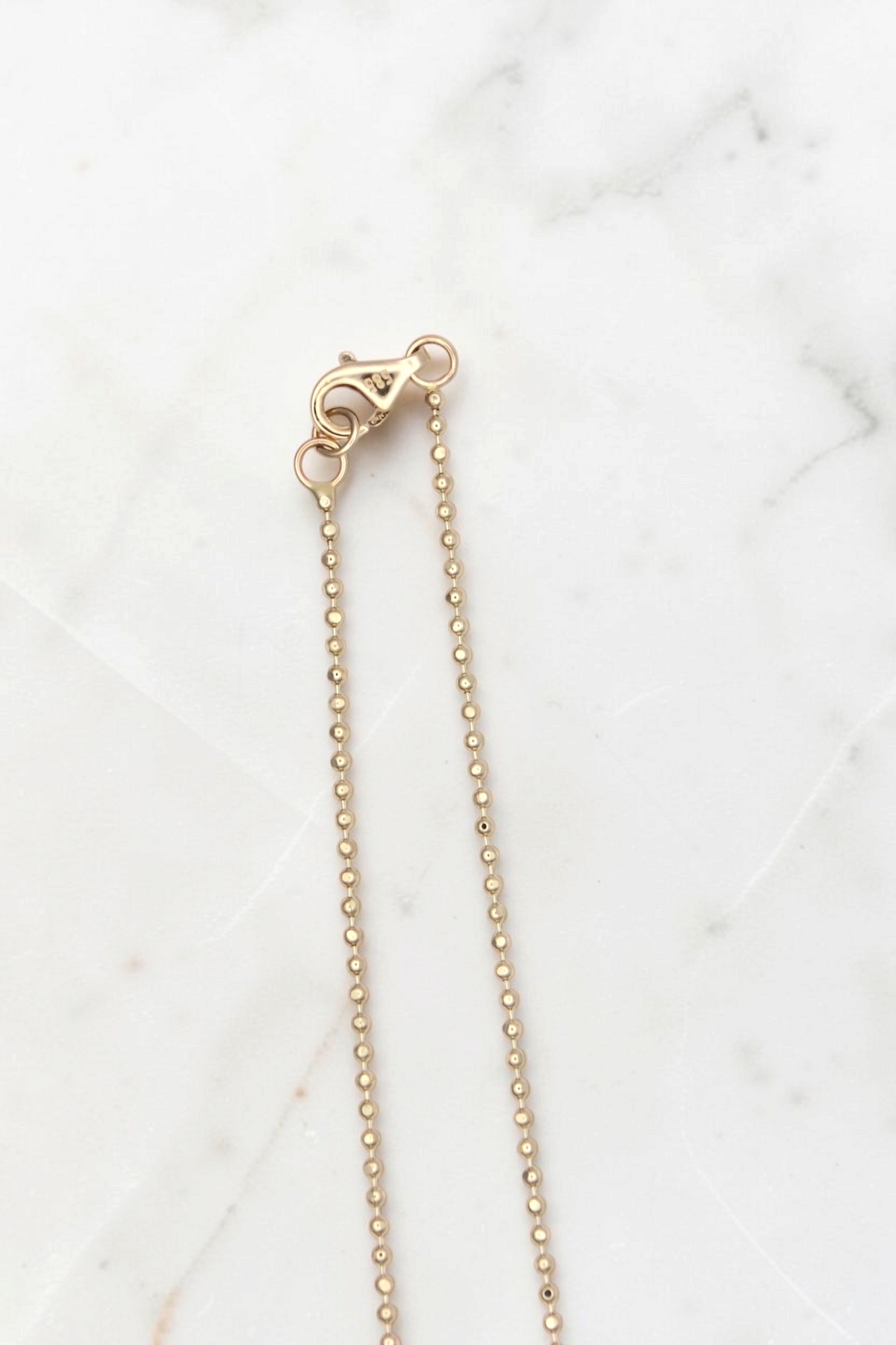 Zafrah 14k solid gold bead chain necklace with a lobster clasp closure, 18 inches in length.