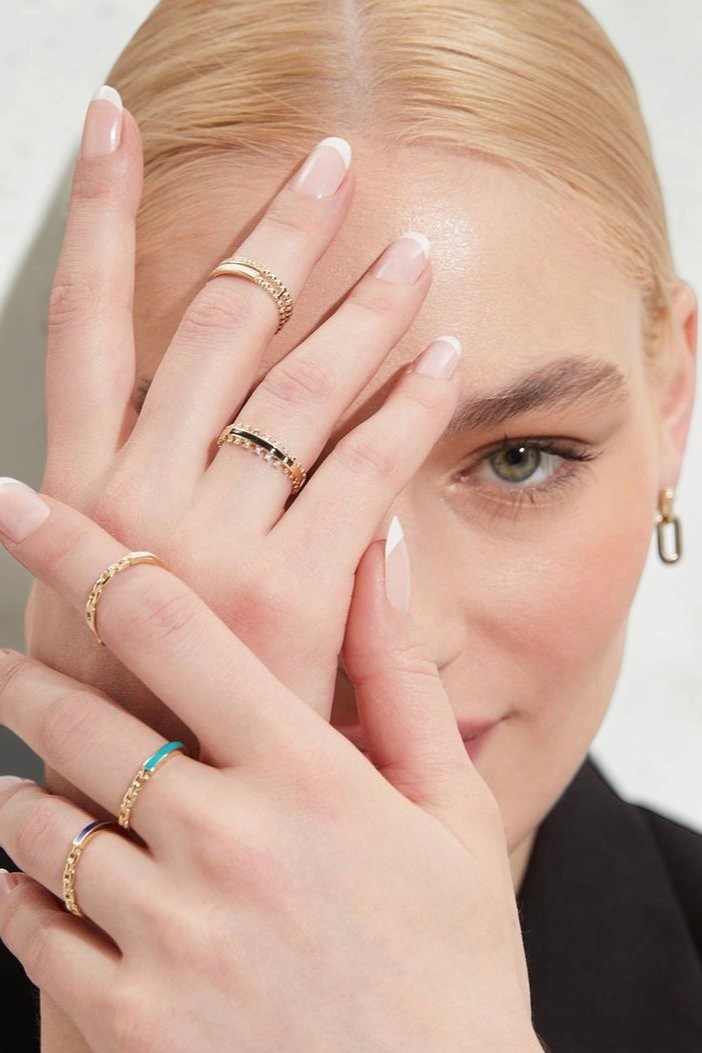 Zafrah 14k solid gold chain link ring worn on a model's finger, showcasing a delicate and elegant jewelry design.