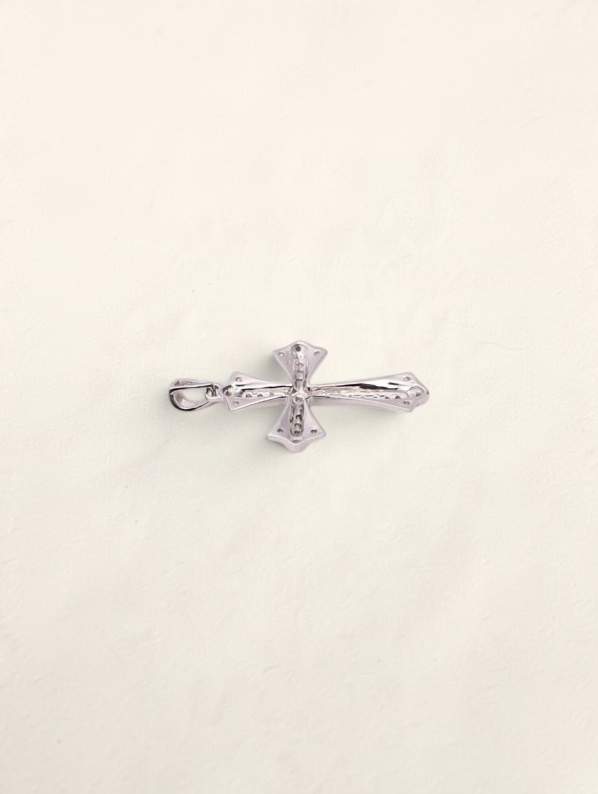 Zafrah 10k white gold cross pendant featuring 0.31ctw round diamonds on a polished metallic surface.