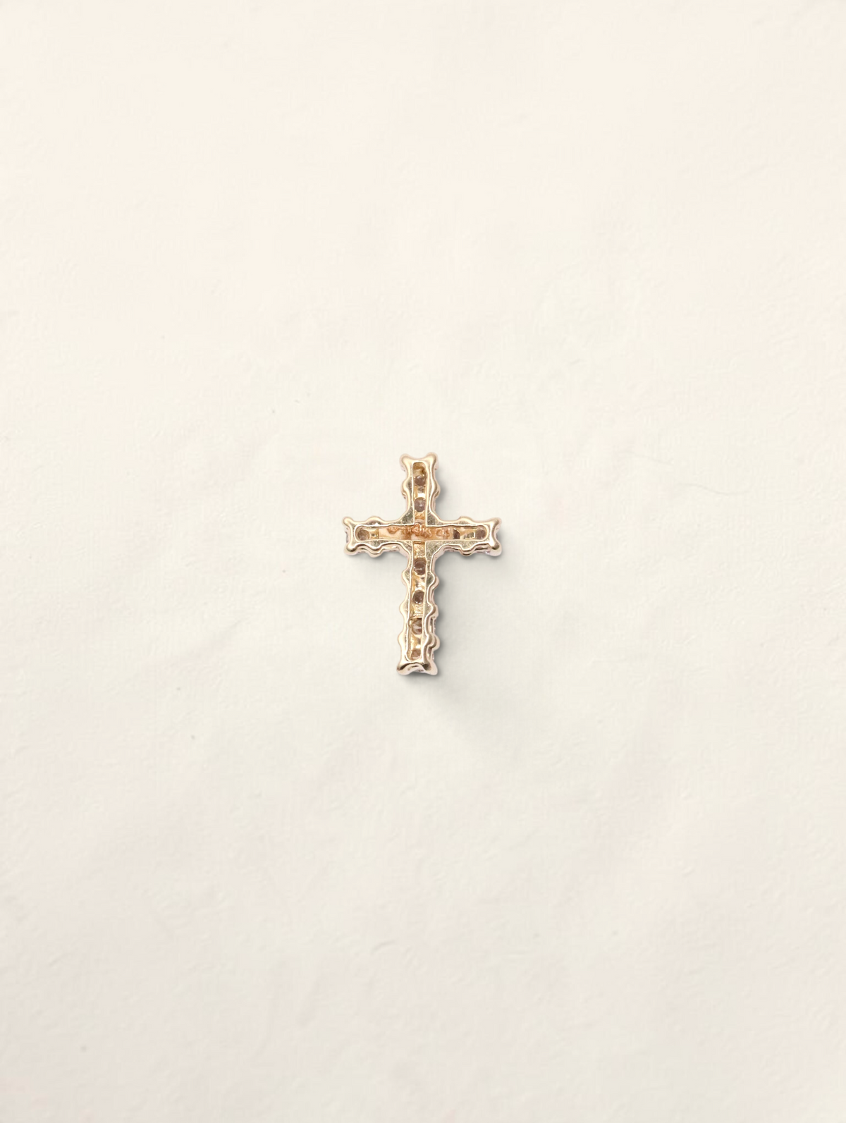 Zafrah 14K yellow gold mini cross pendant featuring 11 round diamonds totaling 0.19ctw on a white background.