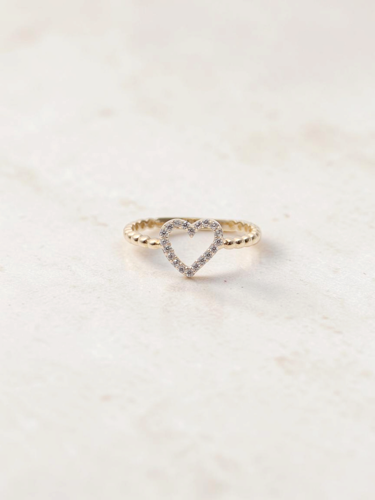 Zafrah 14k yellow gold heart bead ring featuring a delicate band with sparkling CZ stones