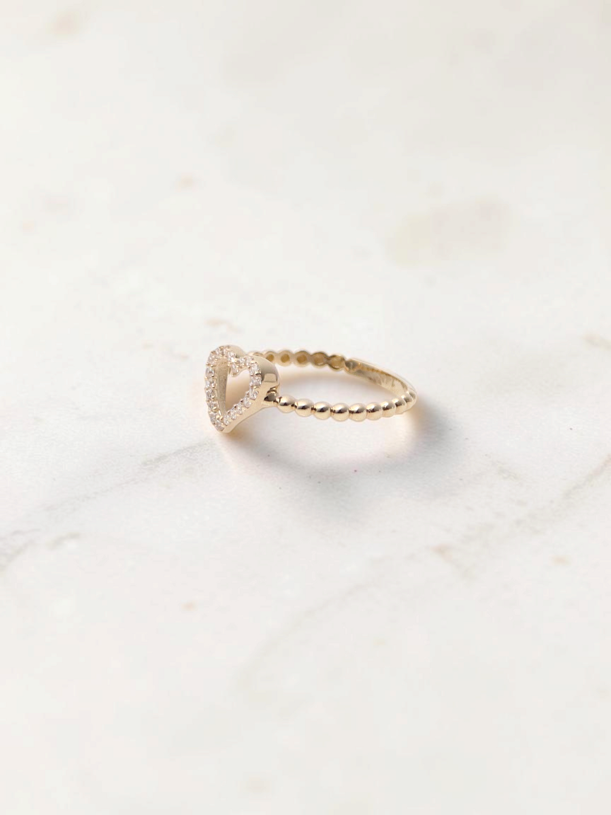 Zafrah 14k yellow gold heart bead ring featuring sparkling CZ stones on a delicate beaded band