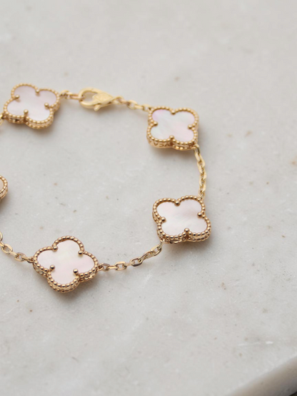Zafrah 14k yellow gold bracelet featuring five mother of pearl clover motifs on a delicate chain