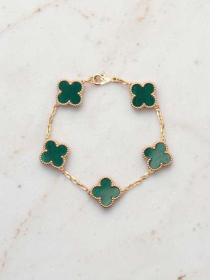 Zafrah 14k yellow gold bracelet featuring five green malachite clover motifs on a delicate chain