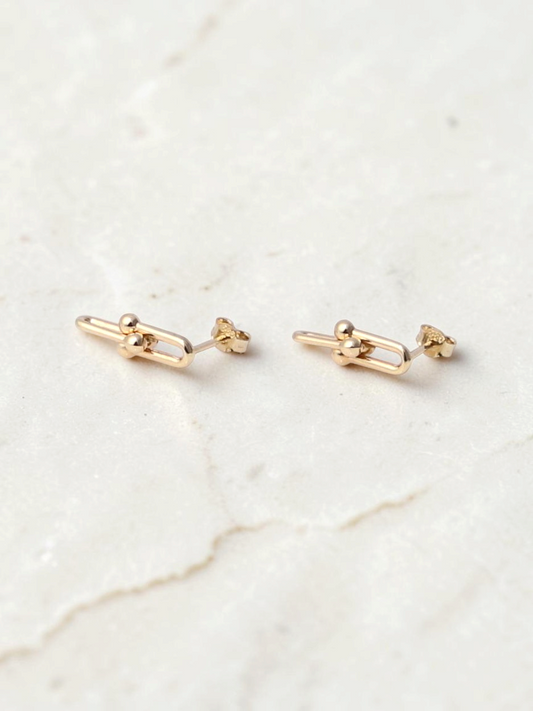Zafrah 14k yellow gold beaded paperclip stud earrings with a polished finish on a white background