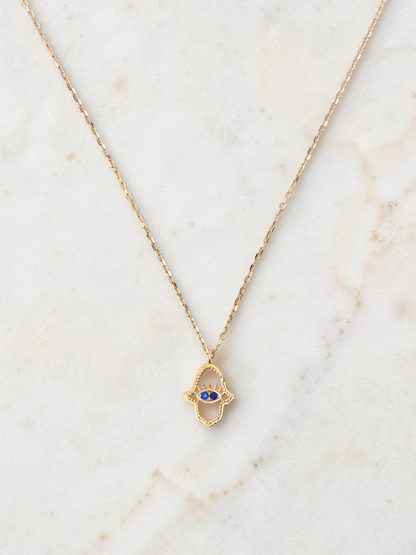 Zafrah 14k yellow gold hamsa eye pendant necklace with two blue stones on a delicate round link chain