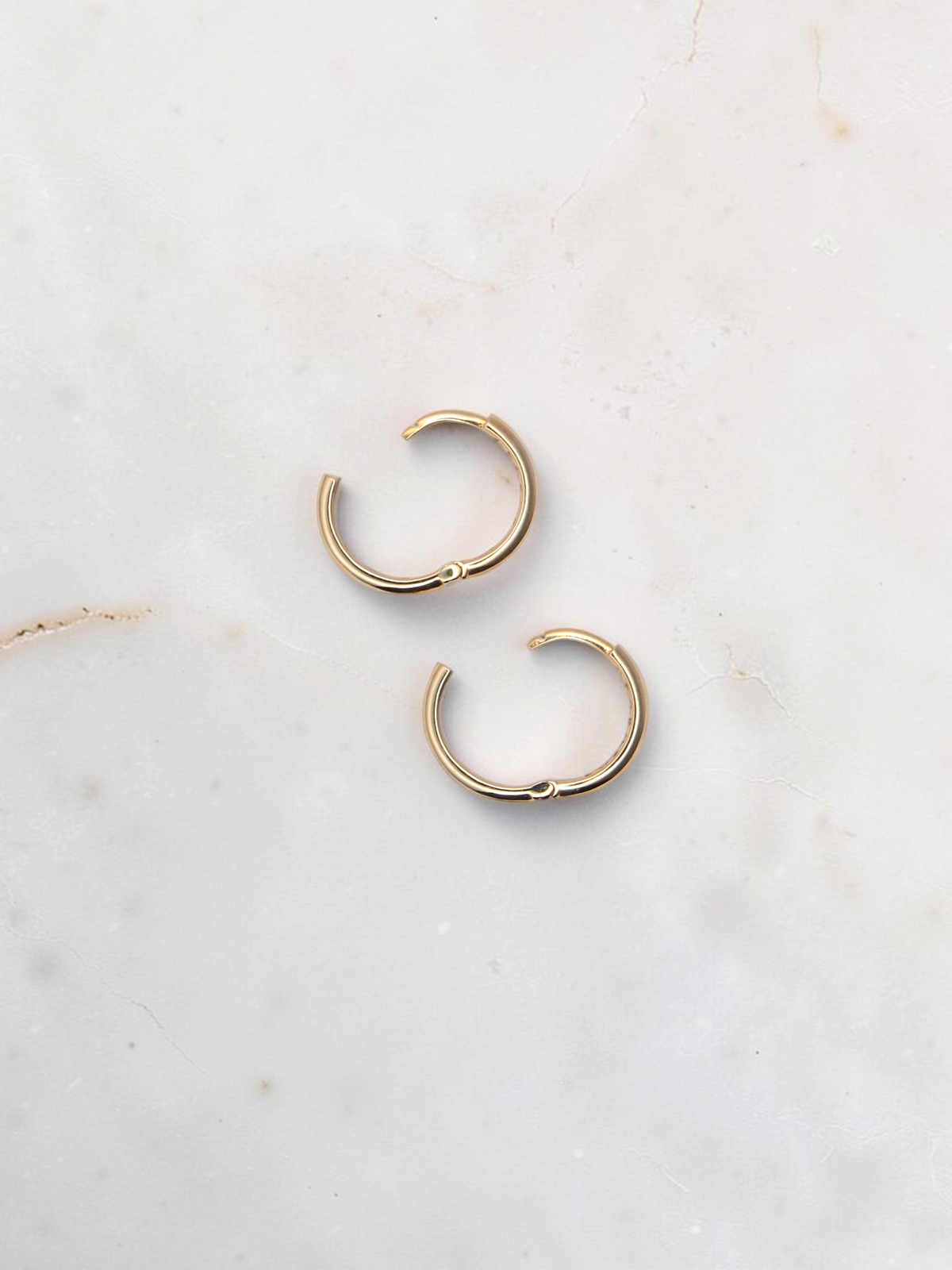 Zafrah 14k yellow gold hoop earrings with a secure snap closure, perfect for everyday wear.