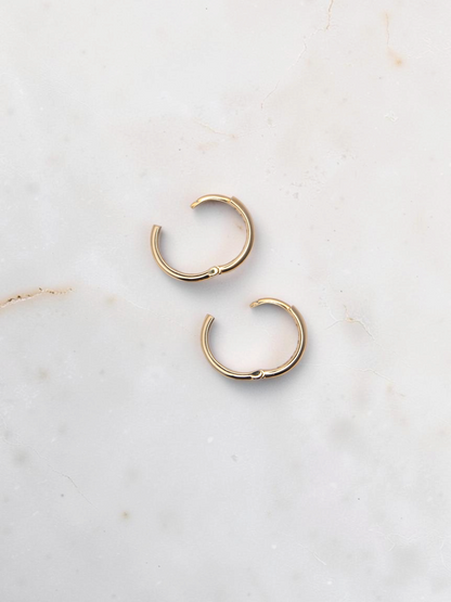 Zafrah 14k yellow gold hoop earrings with a secure snap closure, perfect for everyday wear.