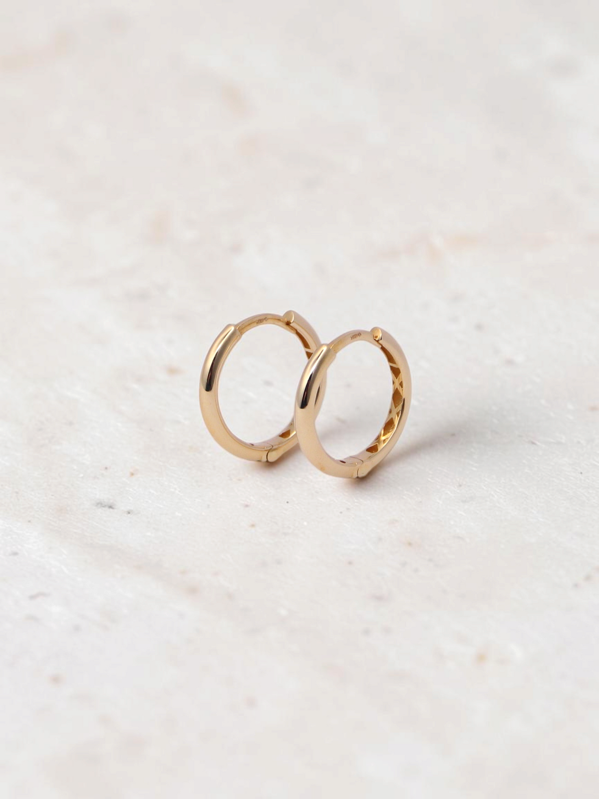 Zafrah 14k yellow gold hoop earrings with a secure snap closure, perfect for everyday wear.