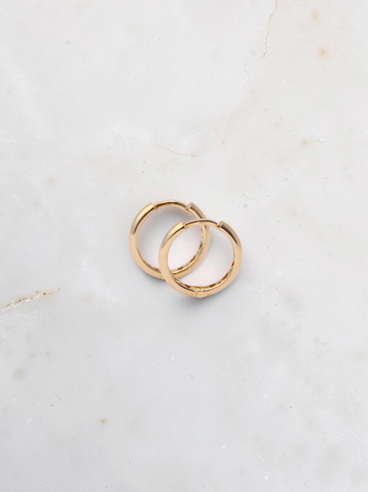 Zafrah 14k yellow gold hoop earrings with a secure snap closure, perfect for everyday wear.