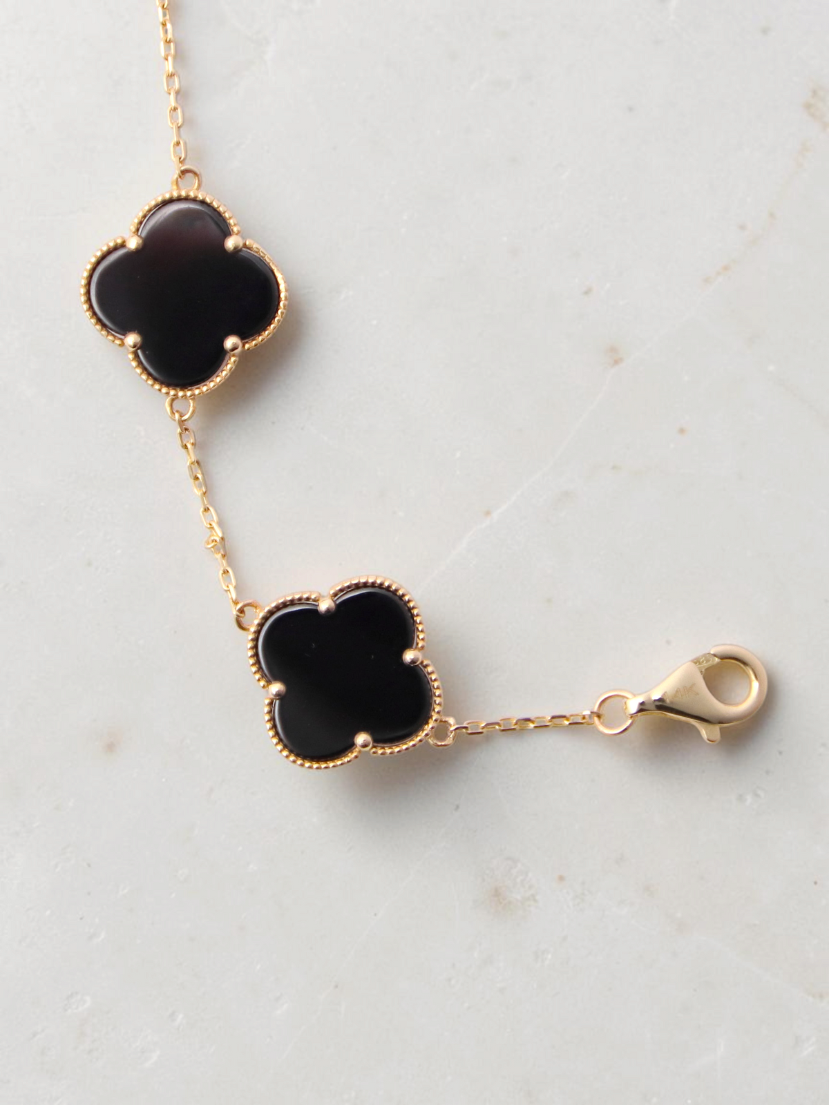 Zafrah gold bracelet featuring black onyx clover motifs with delicate beaded edges and a secure lobster clasp