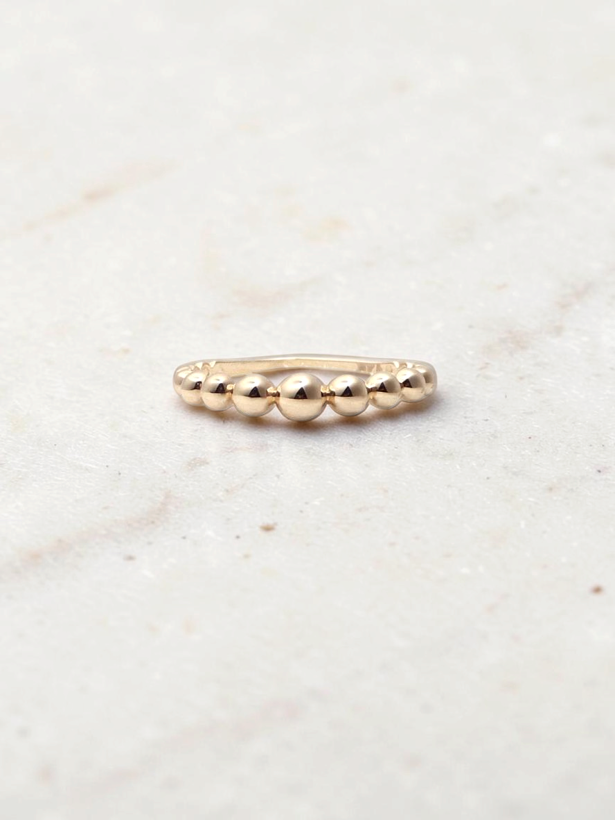 Zafrah 14k yellow gold beaded stacker ring with a delicate polished finish
