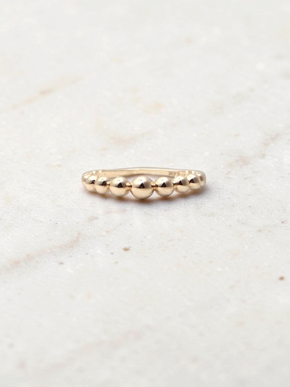 Zafrah 14k yellow gold beaded stacker ring with a delicate polished finish