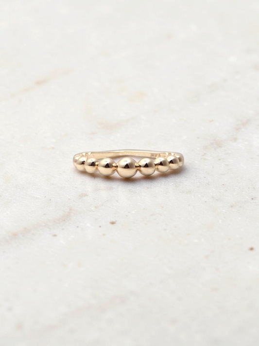 Zafrah 14k yellow gold beaded stacker ring with a delicate polished finish