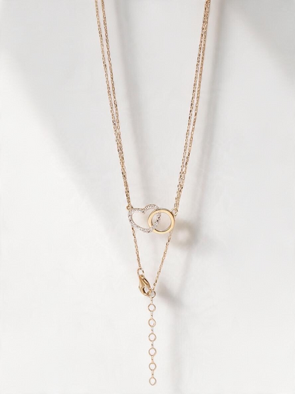 Zafrah interlocking heart necklace in 10k yellow gold with sparkling CZ stones on an adjustable delicate chain