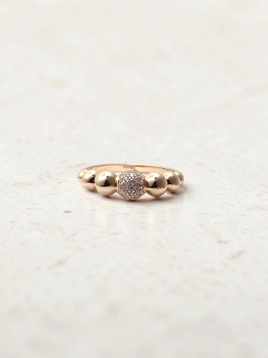 Zafrah 14k yellow gold stacking ring featuring a central pave CZ bubble bead and polished gold spheres