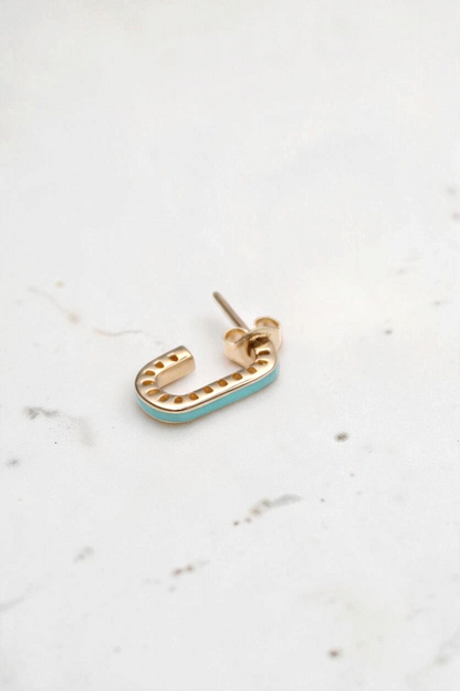 Zafrah dainty 14k solid gold rectangular stud earring with turquoise enamel inlay on a white textured background