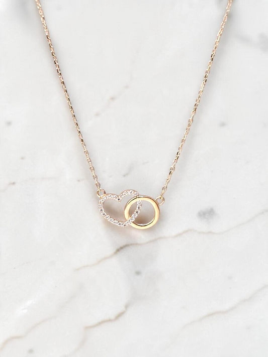 Zafrah interlocking heart necklace in 10k yellow gold with sparkling CZ stones on a delicate adjustable chain.