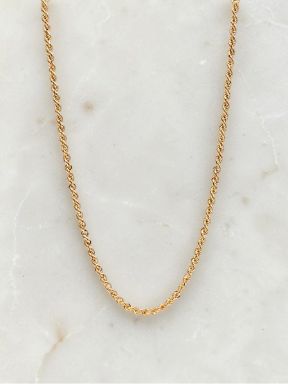 Zafrah 14k yellow gold 3mm rope chain necklace, 21.5 inches long, displayed on a white marble surface.