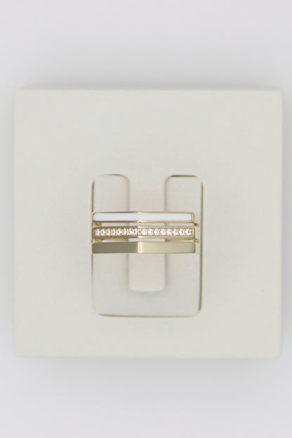 Zafrah 14k solid gold triple line ring featuring a white enamel band and a row of sparkling diamonds.