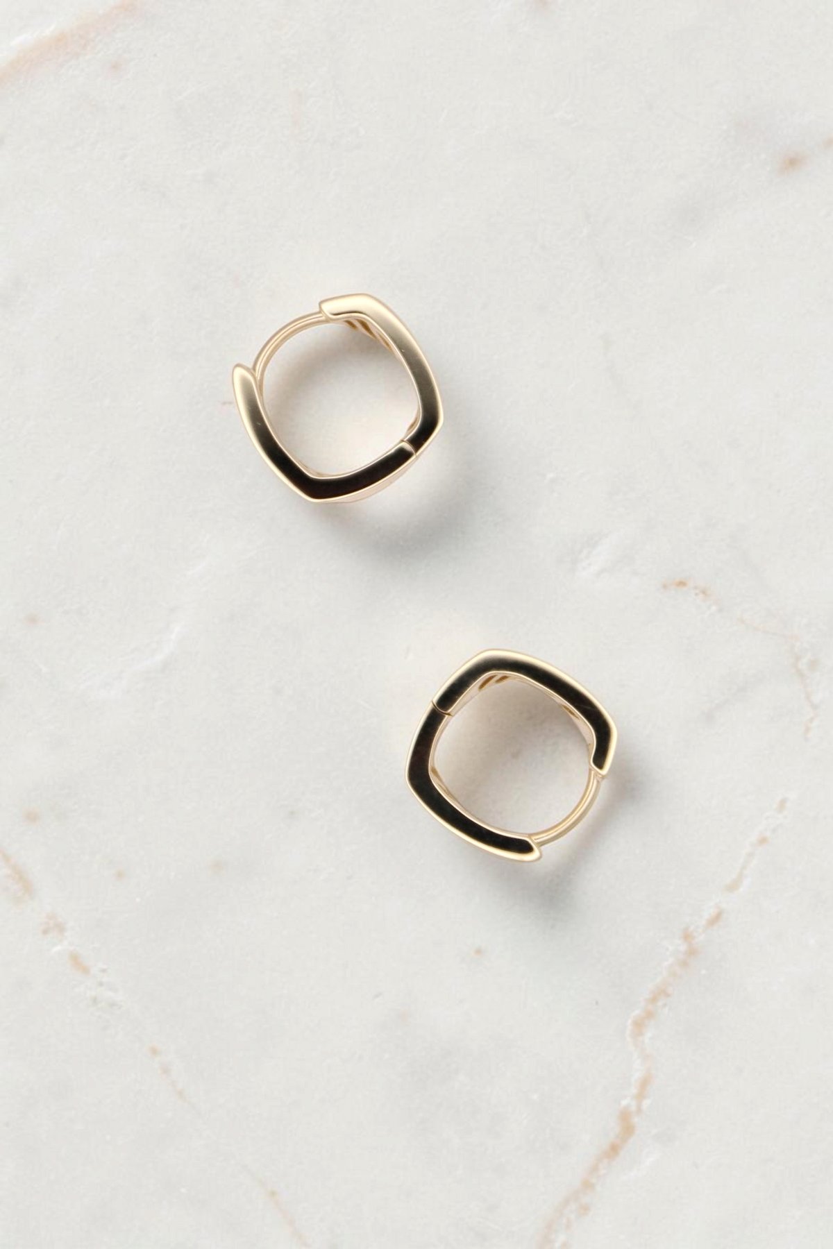 Zafrah thick rectangle huggie hoop earrings crafted in 14k solid gold with a polished finish.