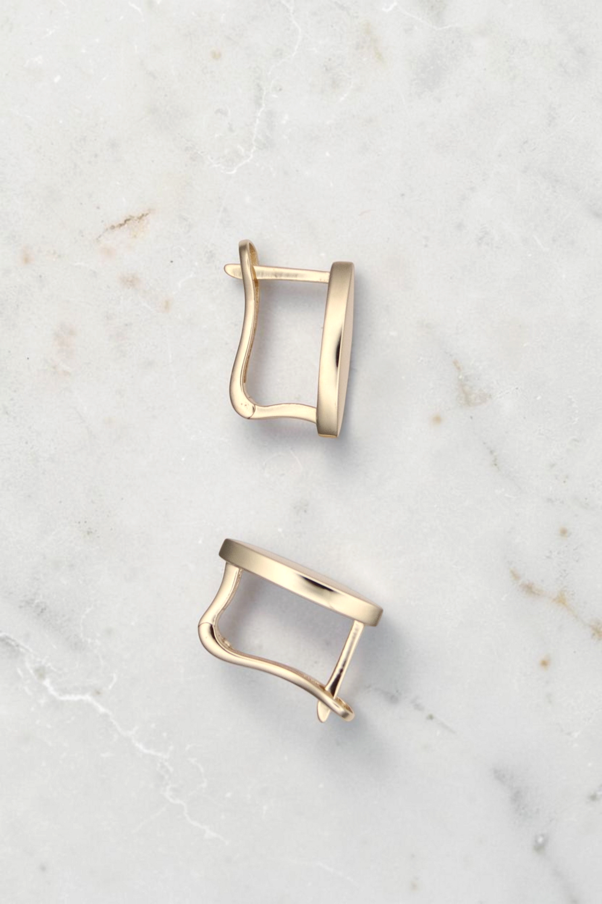Zafrah 14k solid gold vertical marquise earrings with a minimalistic clip design on a neutral background