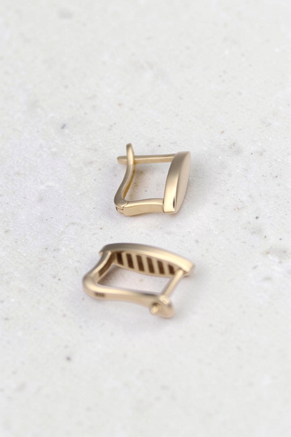 Zafrah 14k solid gold vertical marquise earrings with a minimalistic clip design on a white background.
