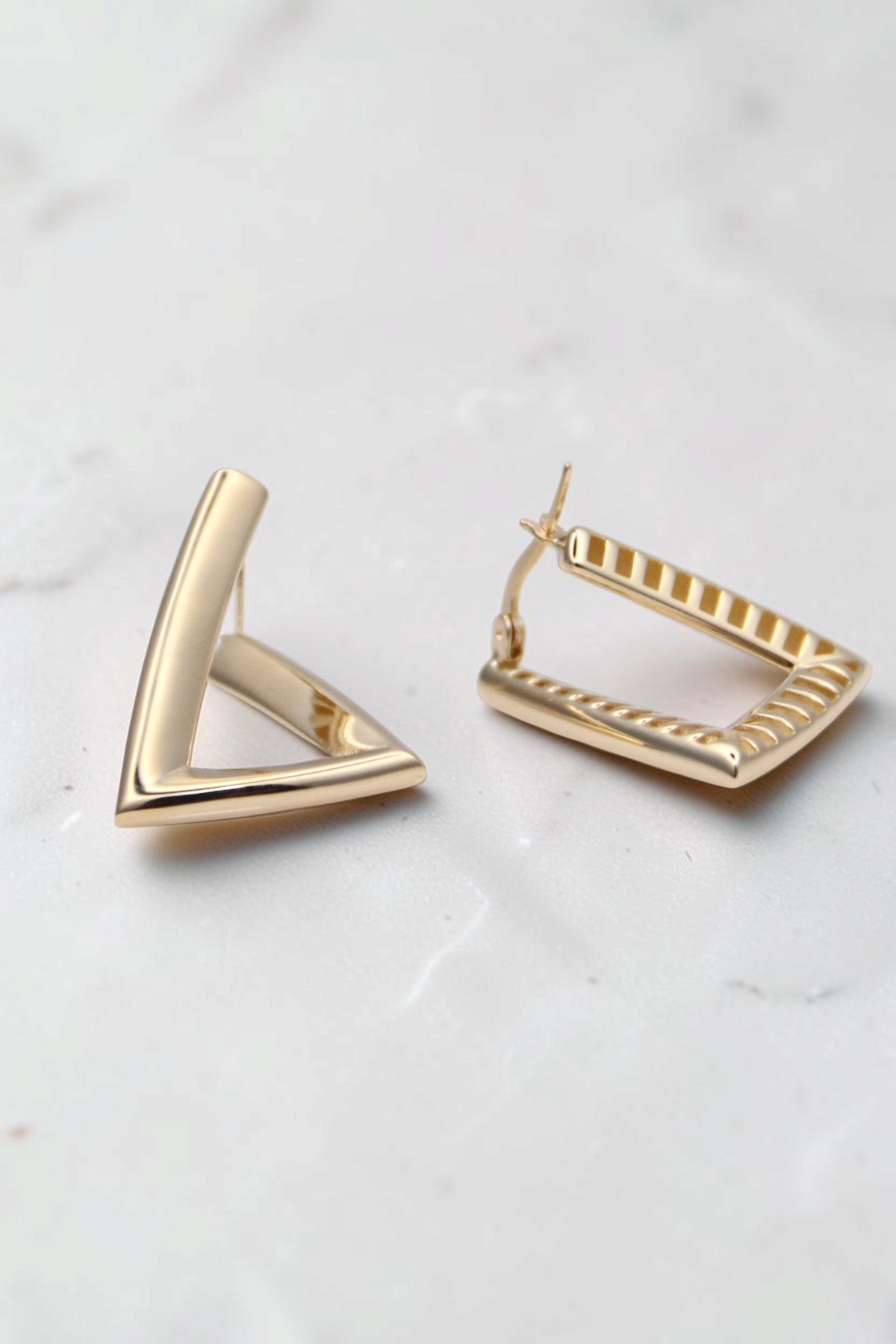 Zafrah 14k solid gold triangular hoop earrings with a minimalist geometric design and polished finish.