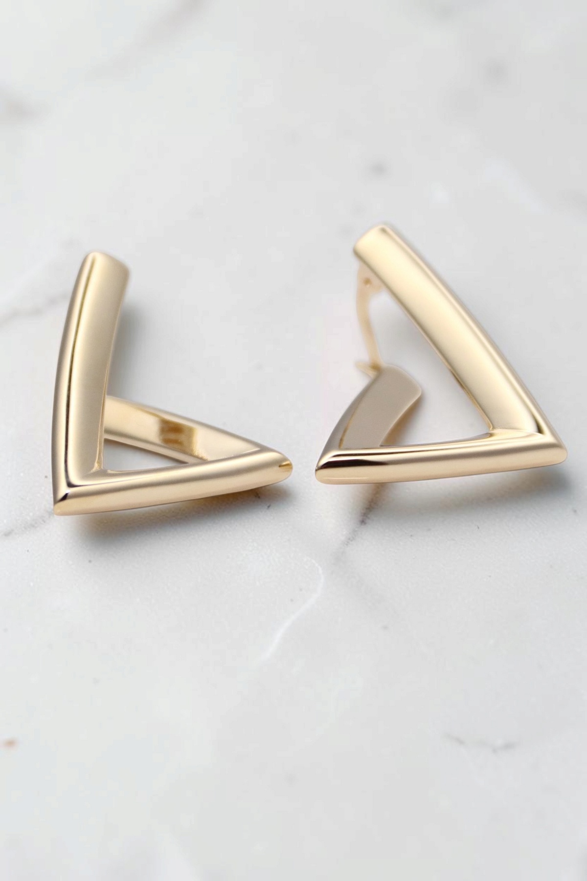 Zafrah minimalist triangular hoop earrings crafted from 14k solid gold with a modern geometric design.