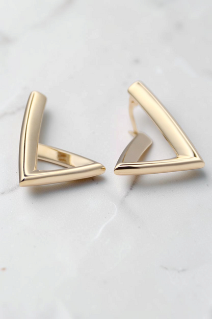 Zafrah minimalist triangular hoop earrings crafted from 14k solid gold with a modern geometric design.