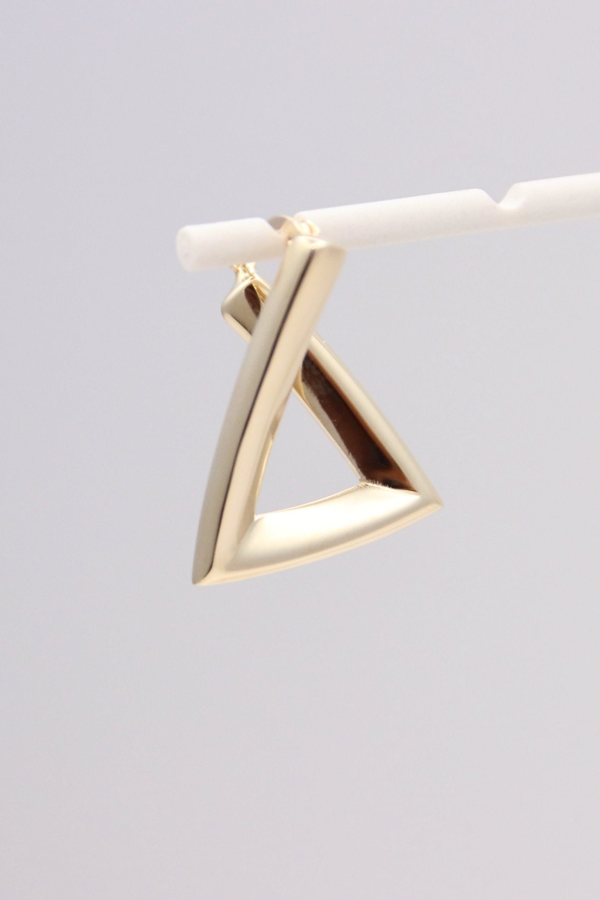 Zafrah 14k solid gold triangular hoop earrings with a minimalist geometric design and polished finish.