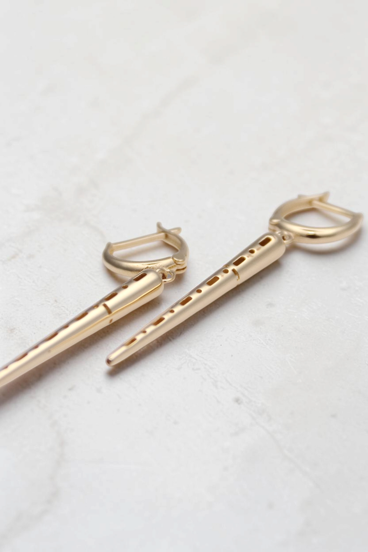 Zafrah 14k solid gold drop hoop earrings featuring polished spiked charms that catch the light.