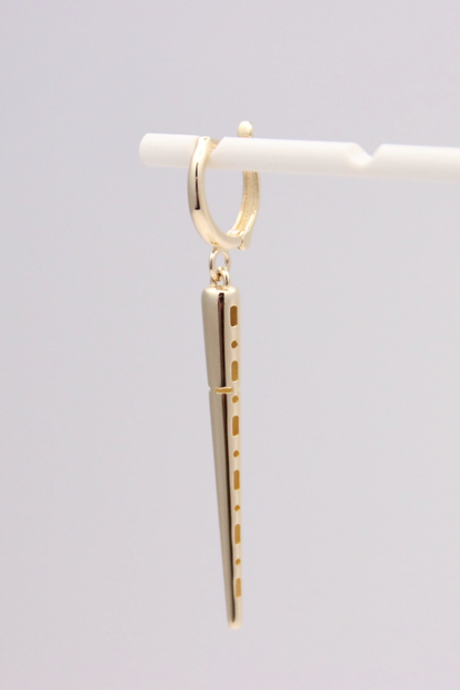 Zafrah 14k solid gold drop hoop earrings featuring a polished spiked charm on a white marble background.