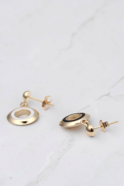 Zafrah 14k solid gold circle earrings featuring black and white enamel inlay, elegant stud design.