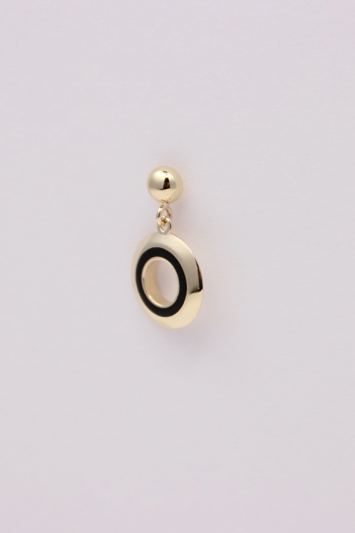 Zafrah 14k solid gold circle earrings featuring a black and white enamel inlay on a white background.