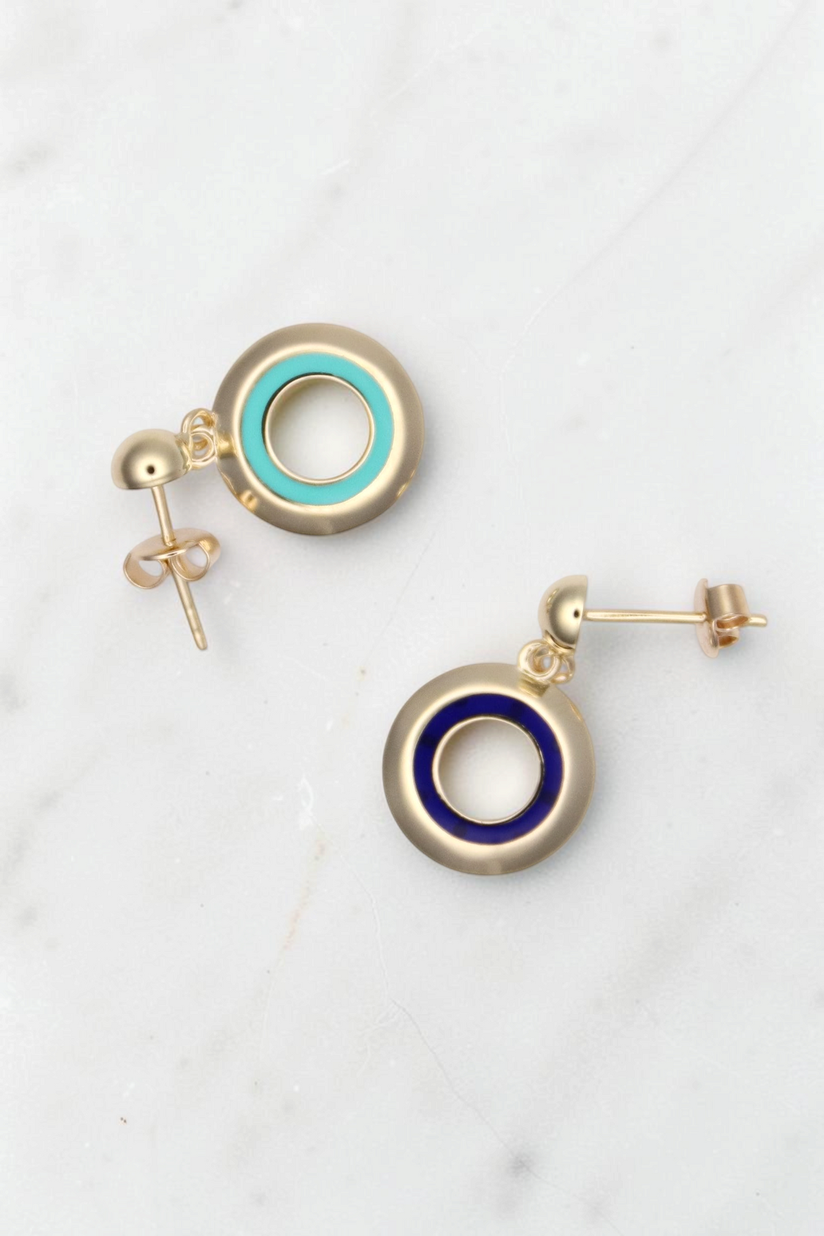 Zafrah 14k solid gold circle earrings featuring one turquoise and one blue enamel inlay, classic stud design.