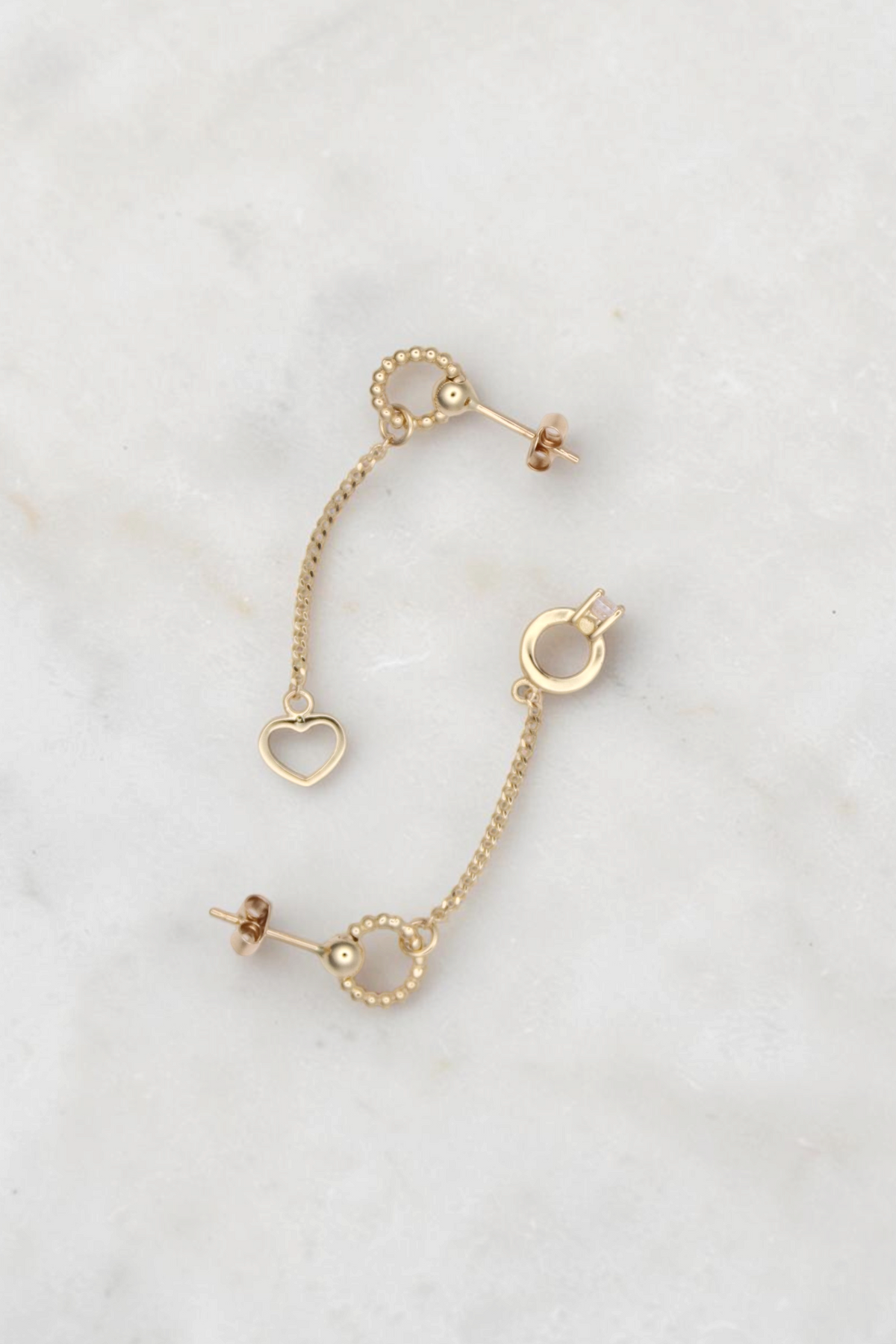 Zafrah 14k solid gold drop earrings featuring a bead ring, open heart charm, and a small ring with a round CZ stone.