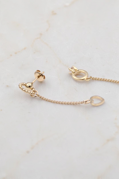 Zafrah 14k solid gold drop earrings featuring a bead ring, open heart charm, and a tiny ring with a round CZ stone.