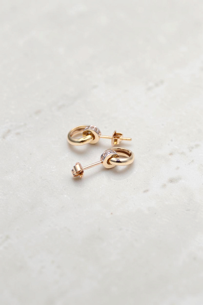 Zafrah 14k solid gold double hoop stud earrings featuring a small stone-encrusted ring and a larger swinging gold ring