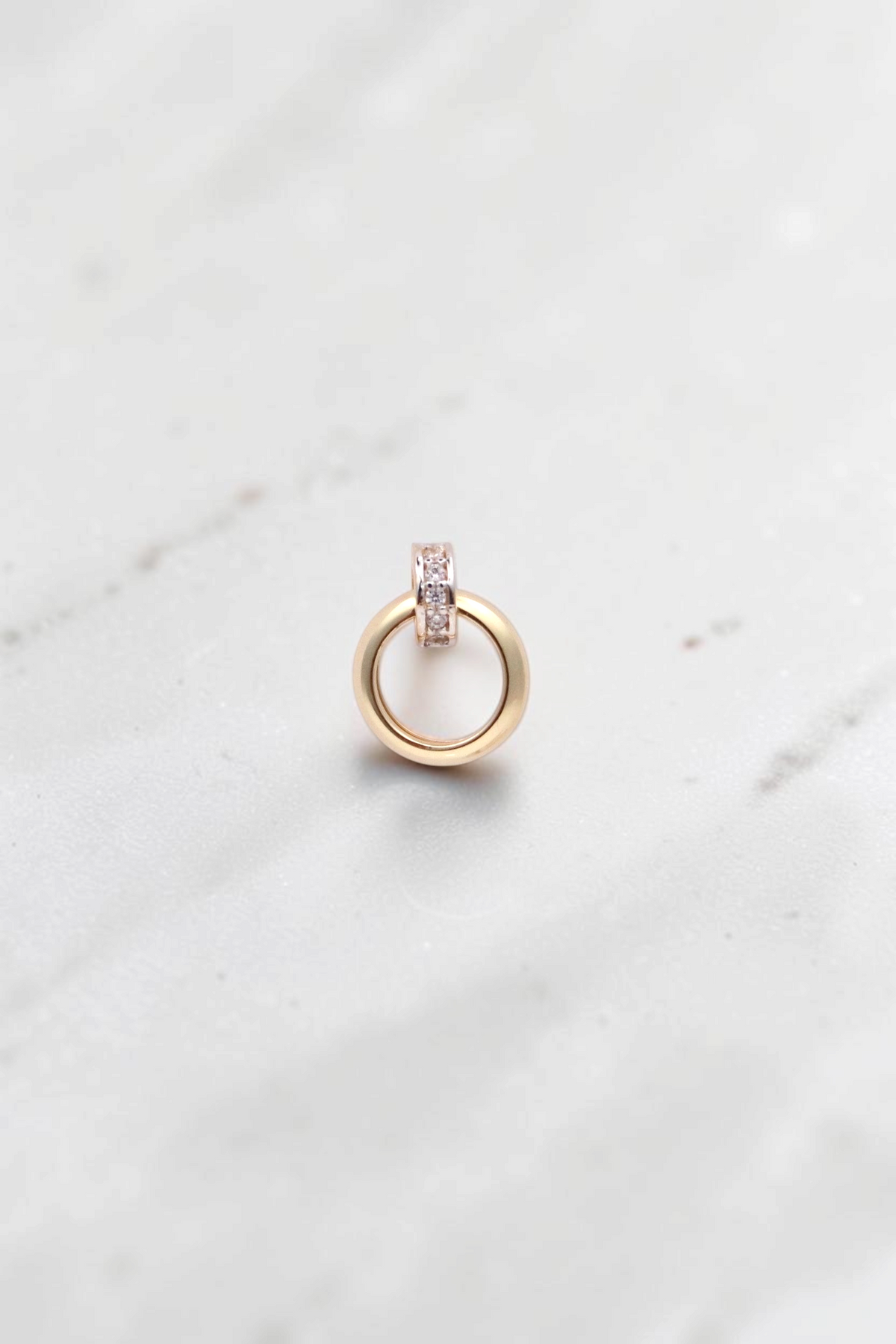 Zafrah 14k solid gold double hoop stud earrings featuring a small stone-set ring and a larger swinging gold hoop.