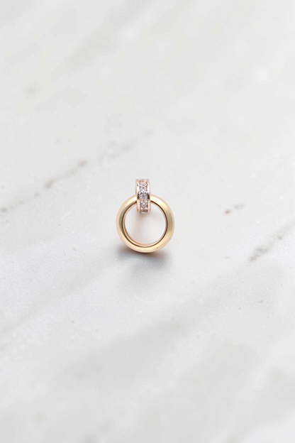 Zafrah 14k solid gold double hoop stud earrings featuring a small stone-set ring and a larger swinging gold hoop.