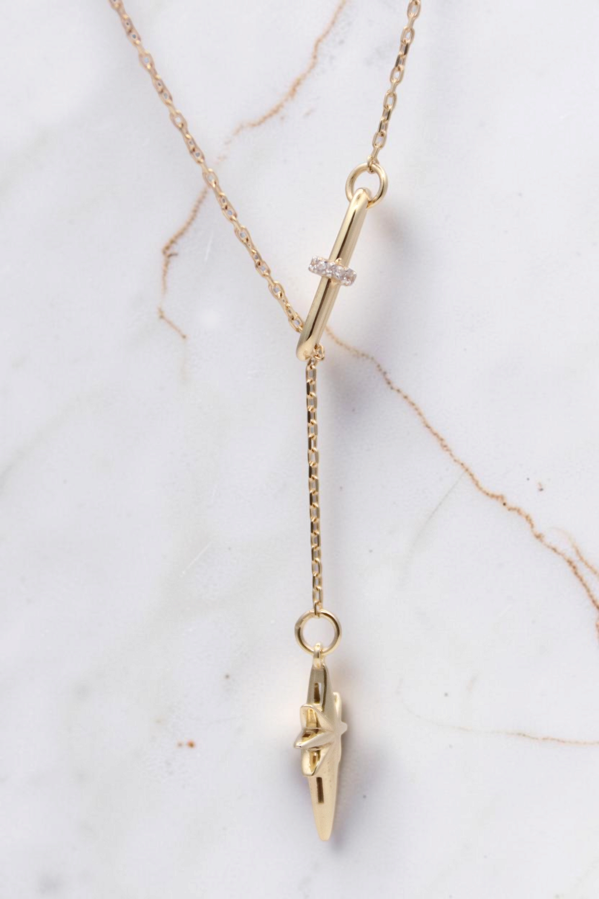 Zafrah 14k solid gold necklace featuring a paper clip link, diamond accent, and a north star pendant charm.