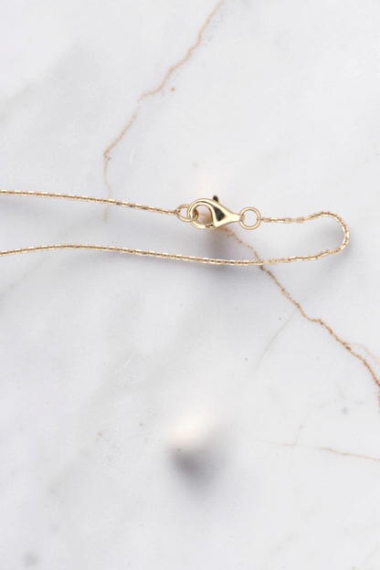 Zafrah 14k solid gold necklace chain featuring a delicate lobster clasp closure on a plain white background