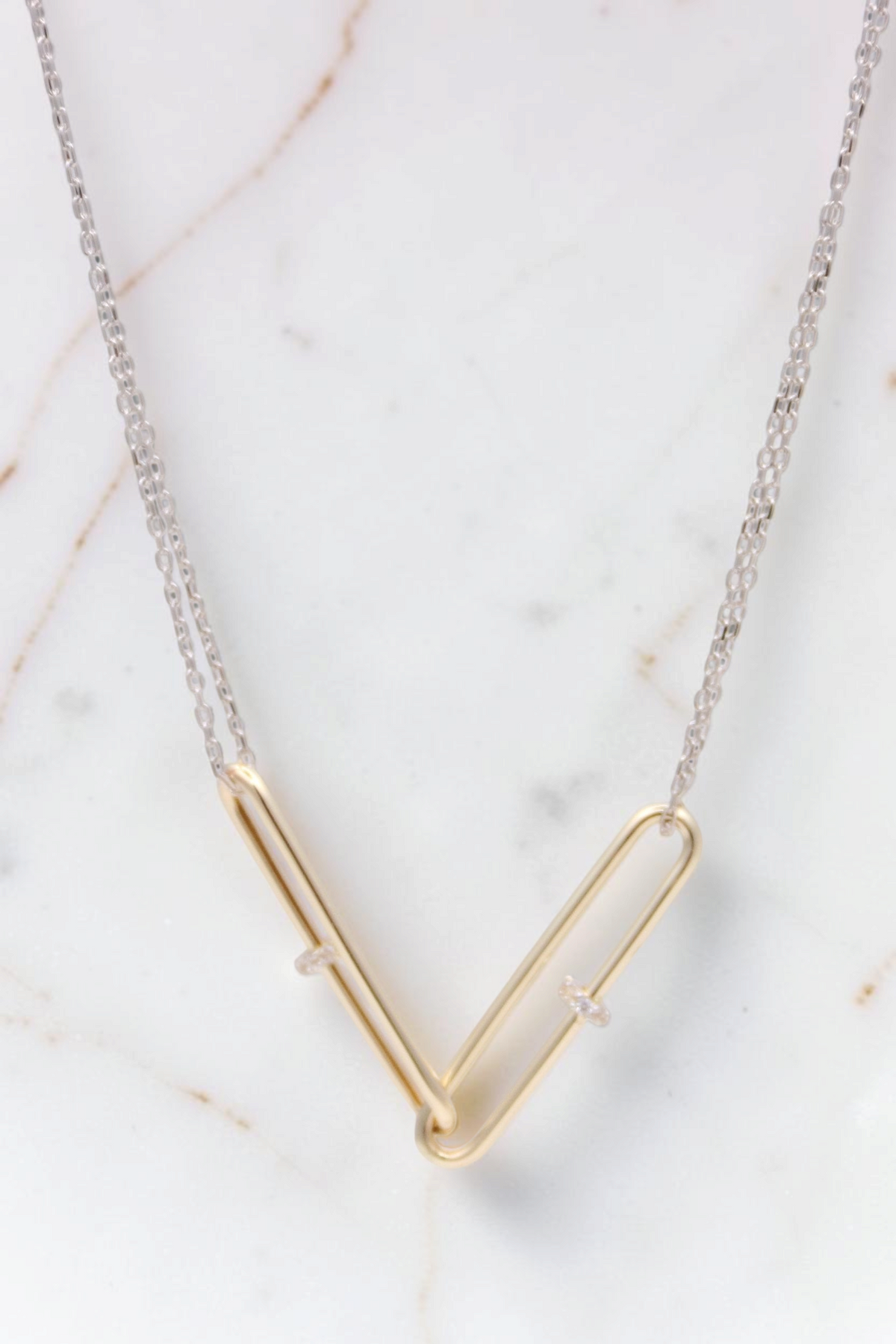 Zafrah 14kt gold double paperclip necklace featuring two interlocking links on a white gold cable chain