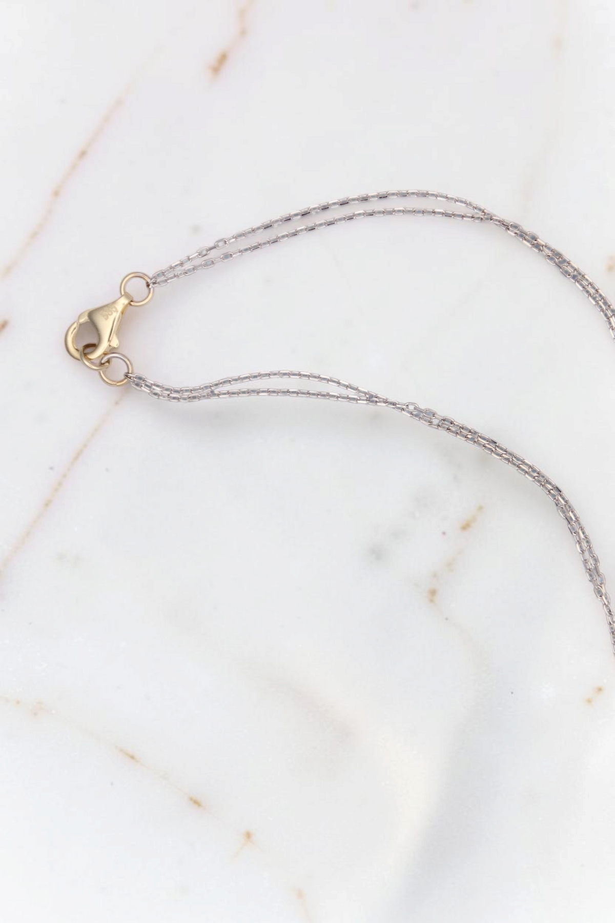 Zafrah 14kt white gold double cable chain necklace with a yellow gold lobster clasp closure