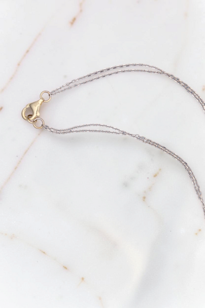 Zafrah 14kt white gold double cable chain necklace with a yellow gold lobster clasp closure