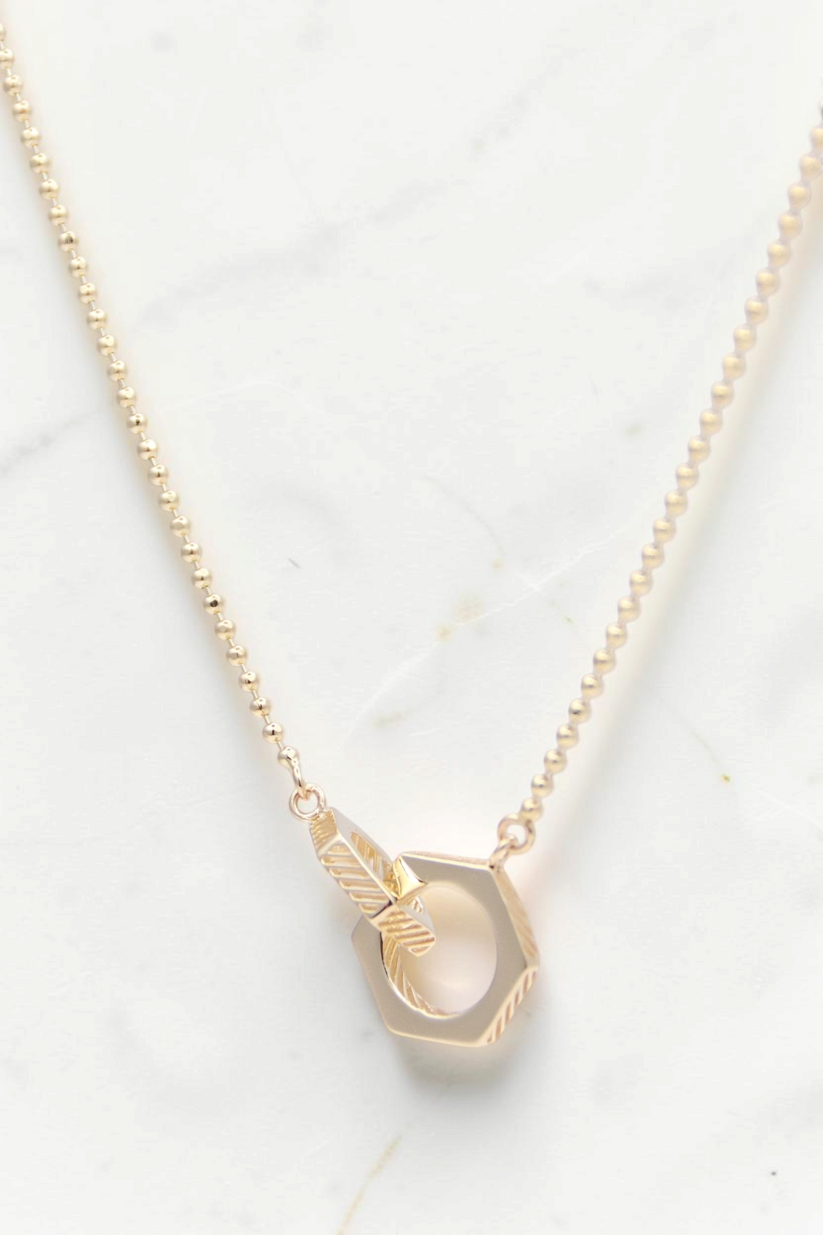 Zafrah 14k solid gold necklace featuring a geometric hexagon duo bead pendant on a delicate beaded chain