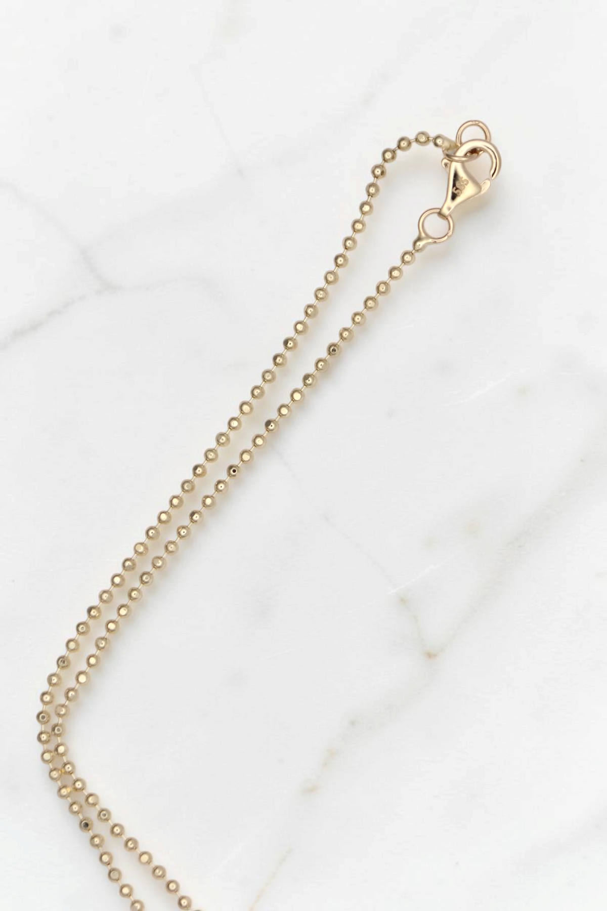 Zafrah 14k solid gold 18-inch duo bead necklace with a lobster clasp closure against a white background.