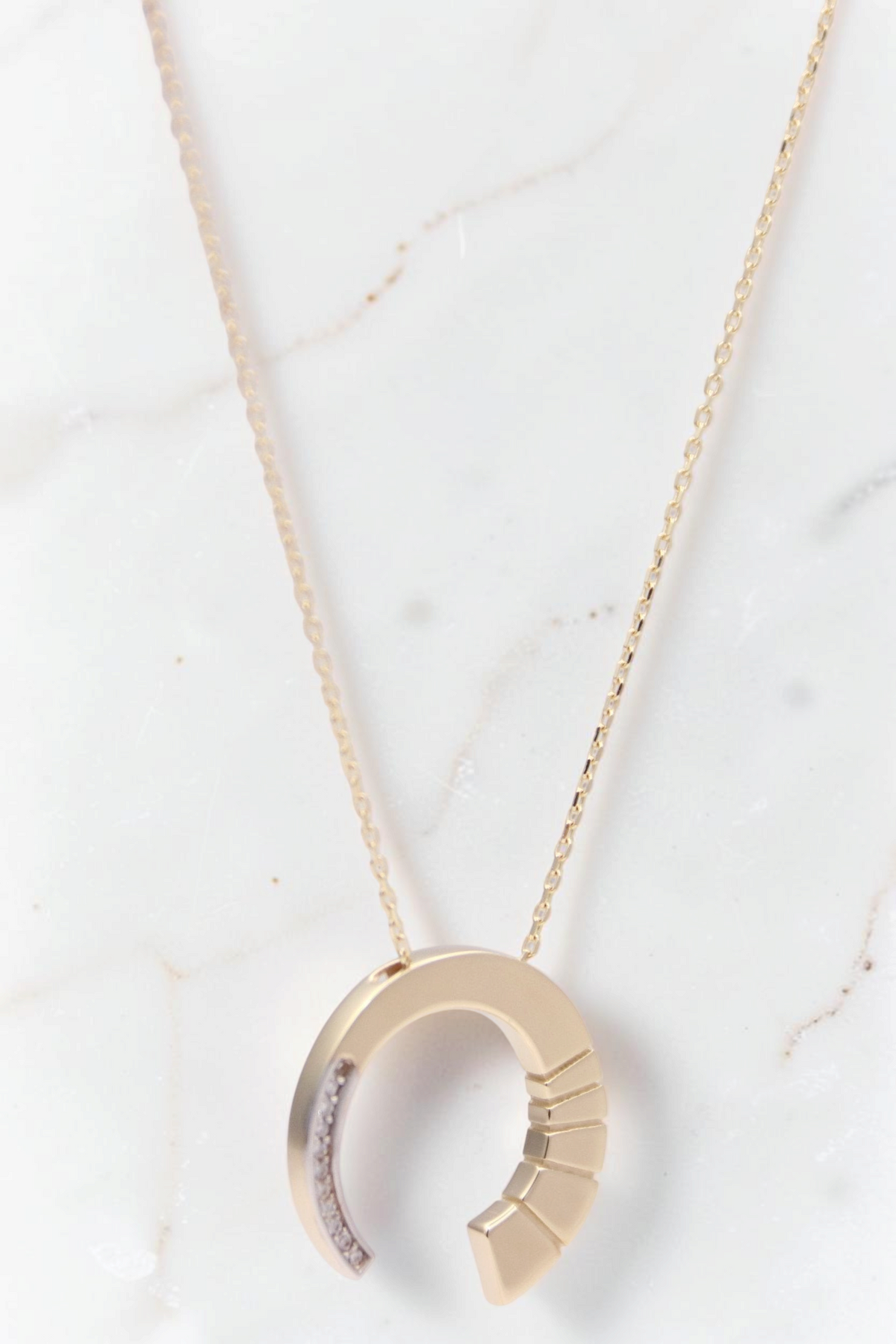 Zafrah 14k gold crescent moon pendant necklace featuring round CZ stones on a delicate chain