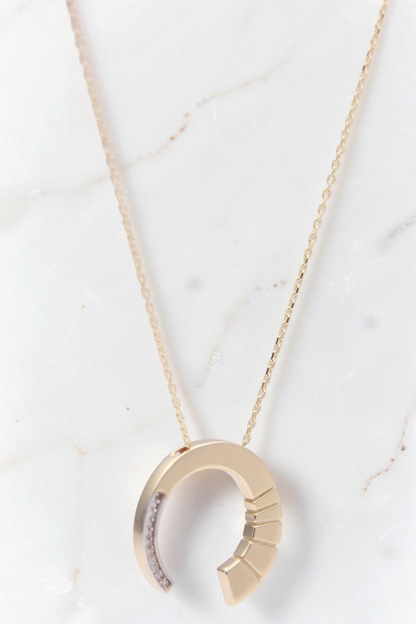 Zafrah 14k gold crescent moon pendant necklace featuring round CZ stones on a delicate chain
